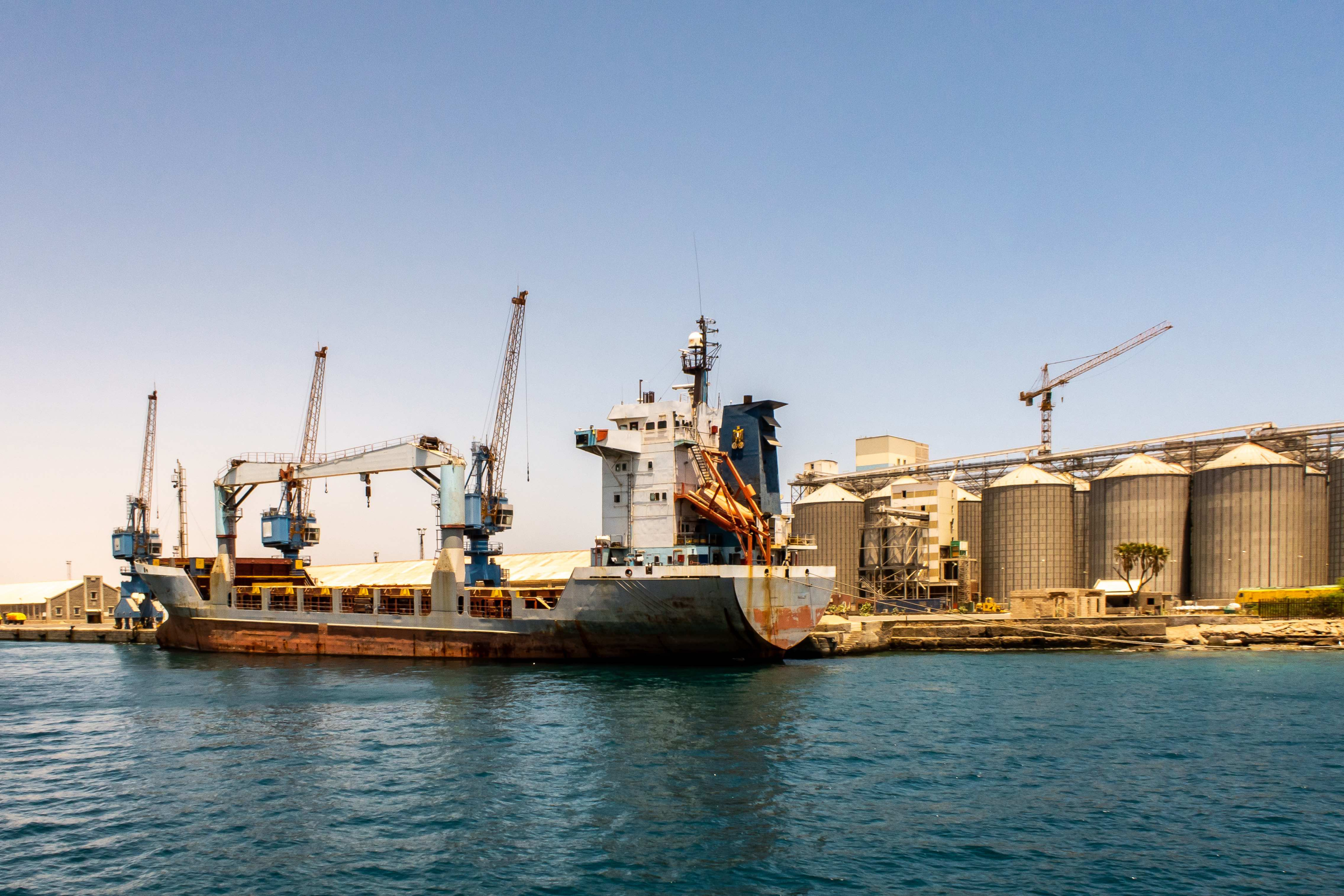 A large container ship is loaded with cargo in Port Sudan.