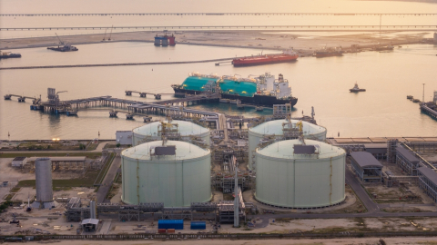 Liquified Natural Gas  tanker anchored in Gas terminal gas tanks for storage.