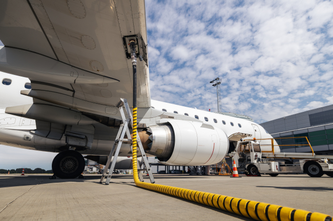 Refueling of airplane at airport. 