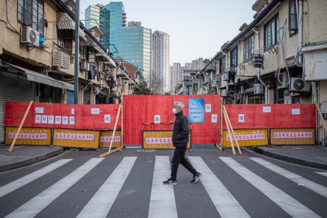 Shanghai, China - Feb. 23, 2020: The community blocks the main street leading to a residential area, during the Wuhan coronavirus outbreak. 
