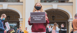 Saint Petersburg, August 2020: a protester holds a poster "When will Russia come out of coma?" at a rally.
