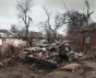 A destroyed Ukrainian tank surrounded by destroyed houses in the suburbs of Chernihiv