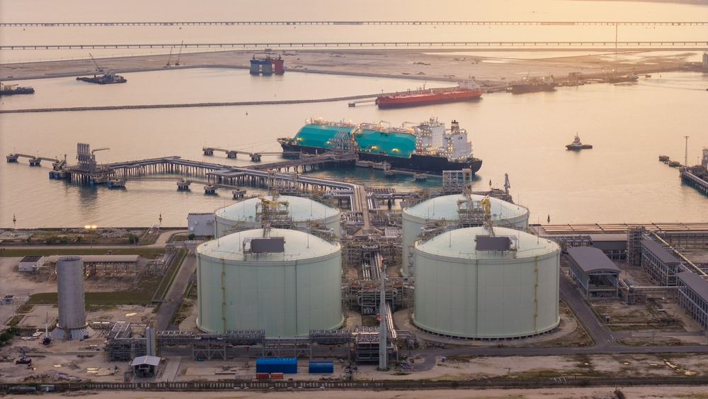 Liquified Natural Gas  tanker anchored in Gas terminal gas tanks for storage.